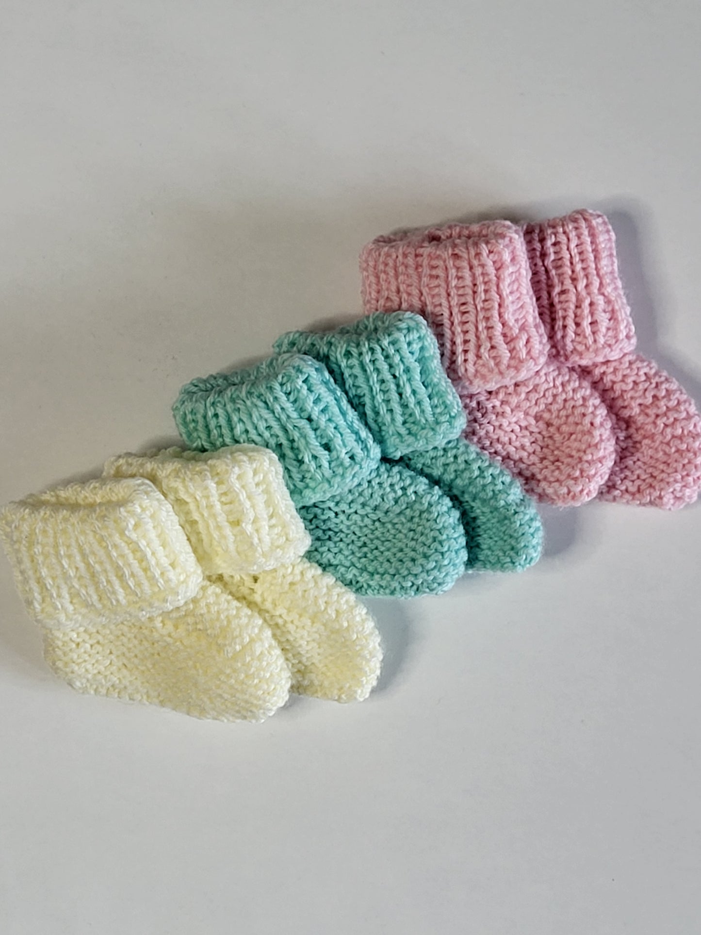 Knitted baby beanie hats and baby boots set